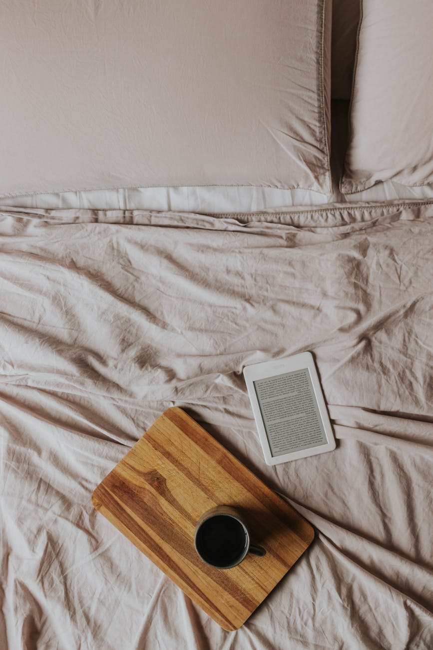 cozy bedroom scene with e reader and coffee